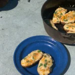 A blue plate with two pieces of food on it