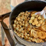 A pan of food with fried potatoes and other foods.