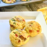 Three mini quiches are sitting on a plate.