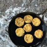 A pan of food sitting on top of the ground.