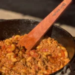 A pan of macaroni and cheese with meat in it.