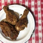 A plate of fried chicken on top of a table.