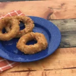 A blue plate with some fried food on it