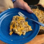 A blue plate with macaroni and cheese on it