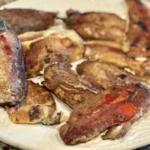 A plate of meat on top of a table.