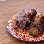 A plate of food on top of a wooden table.