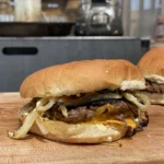 A close up of a burger on top of a bun