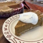 A piece of pie sitting on top of a white plate.