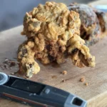 A knife and some food on top of a cutting board.