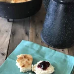 A plate of biscuits and jam on top of a table.