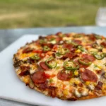 A pizza sitting on top of a white plate.