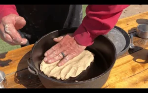 A person is making food in a pot.