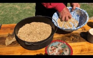 A person is putting food in a pan