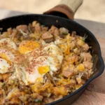 A pan of food with an egg on top.