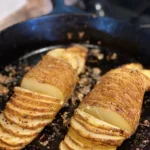 A pan with some potatoes in it on the stove