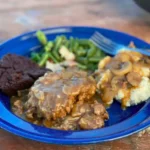 A blue plate with some food on it