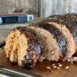 A close up of a meat loaf on a cutting board