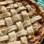 A close up of an apple pie with lattice crust.