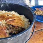 A pot of food on top of a table.