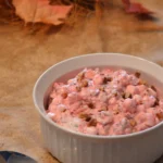 A bowl of food on top of a table.