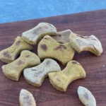 A wooden table with some dog treats on it