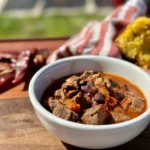 A bowl of chili with beans and corn.