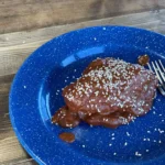 A blue plate with some food on it