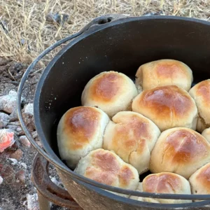 A pot of bread sitting on top of the ground.