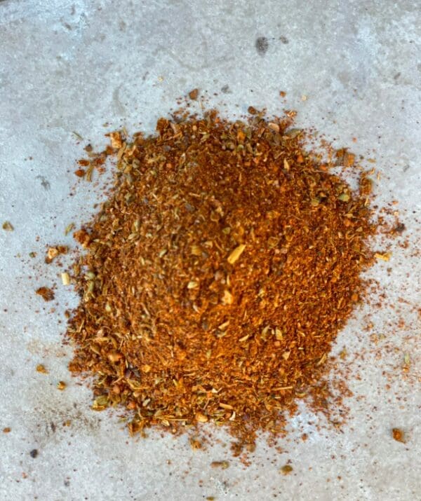 A pile of brown and red spice blend.