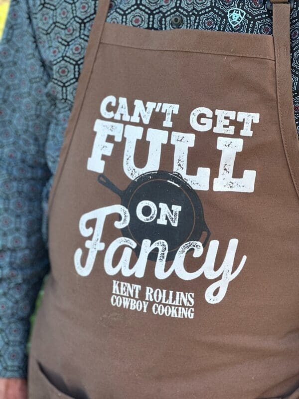 Brown apron with "Can't get full on fancy" text.