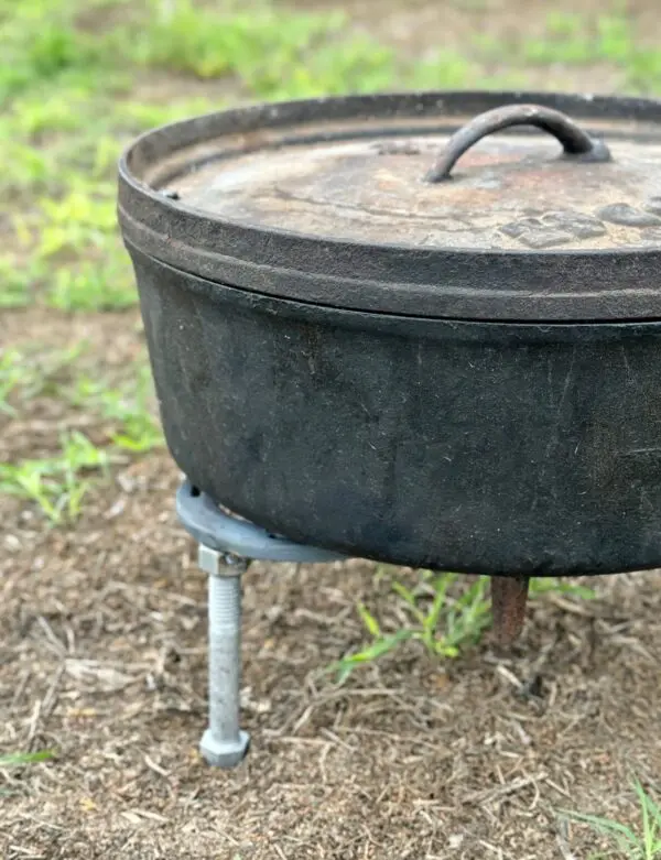 Cast iron pot on a tripod stand.