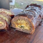 Bacon-wrapped sausage stuffed with egg and potato.