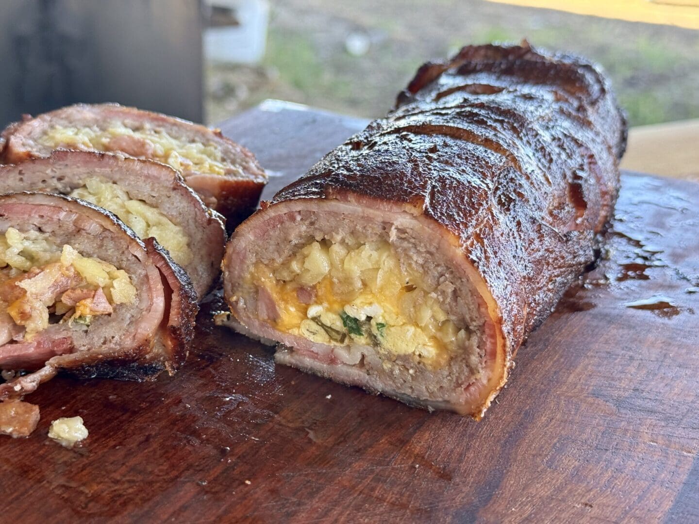 Bacon-wrapped sausage stuffed with egg and potato.