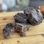 Chocolate brownie bites on a wooden table.