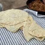 Kent Rollins Flour Tortillas laid out on a seersucker towel