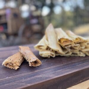 Tamales and mini tamales on wood board.