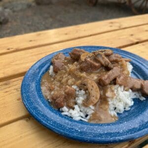 Cowboy Kent Rollins beef tips and rice on a blue enamel plate