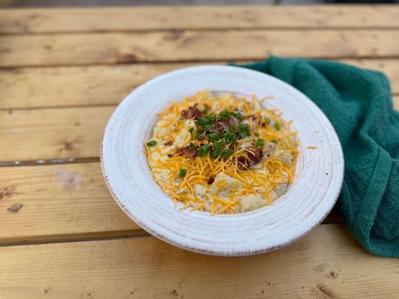 A white bowl with loaded baked potato soup