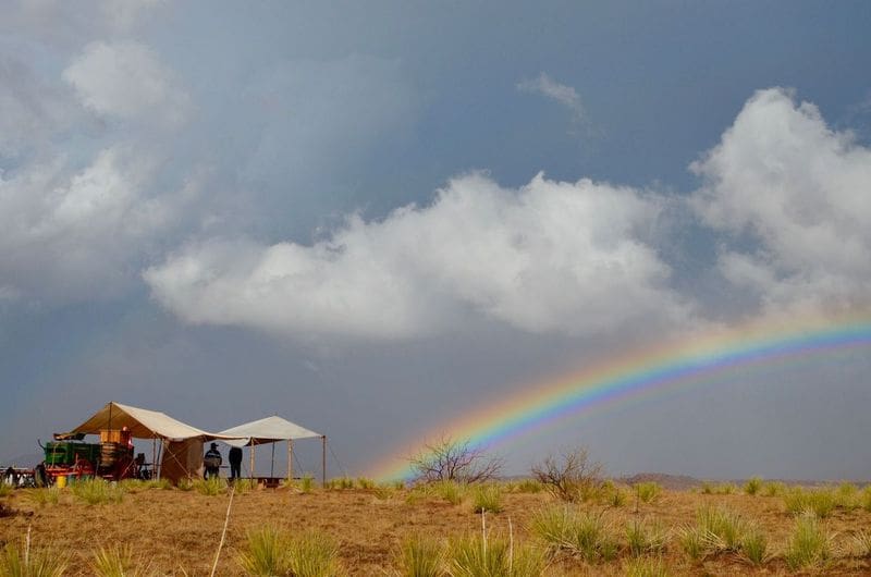 A rainbow ends in camp