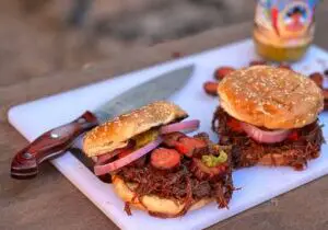 Kent Rollins' Diablo Sandwich. Brisket, hot links, red onion, tangy mustard on a toasted sesame seed bun.