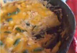 Kent Rollins' Refried Beans, topped with melted cheese and garnished with green onions