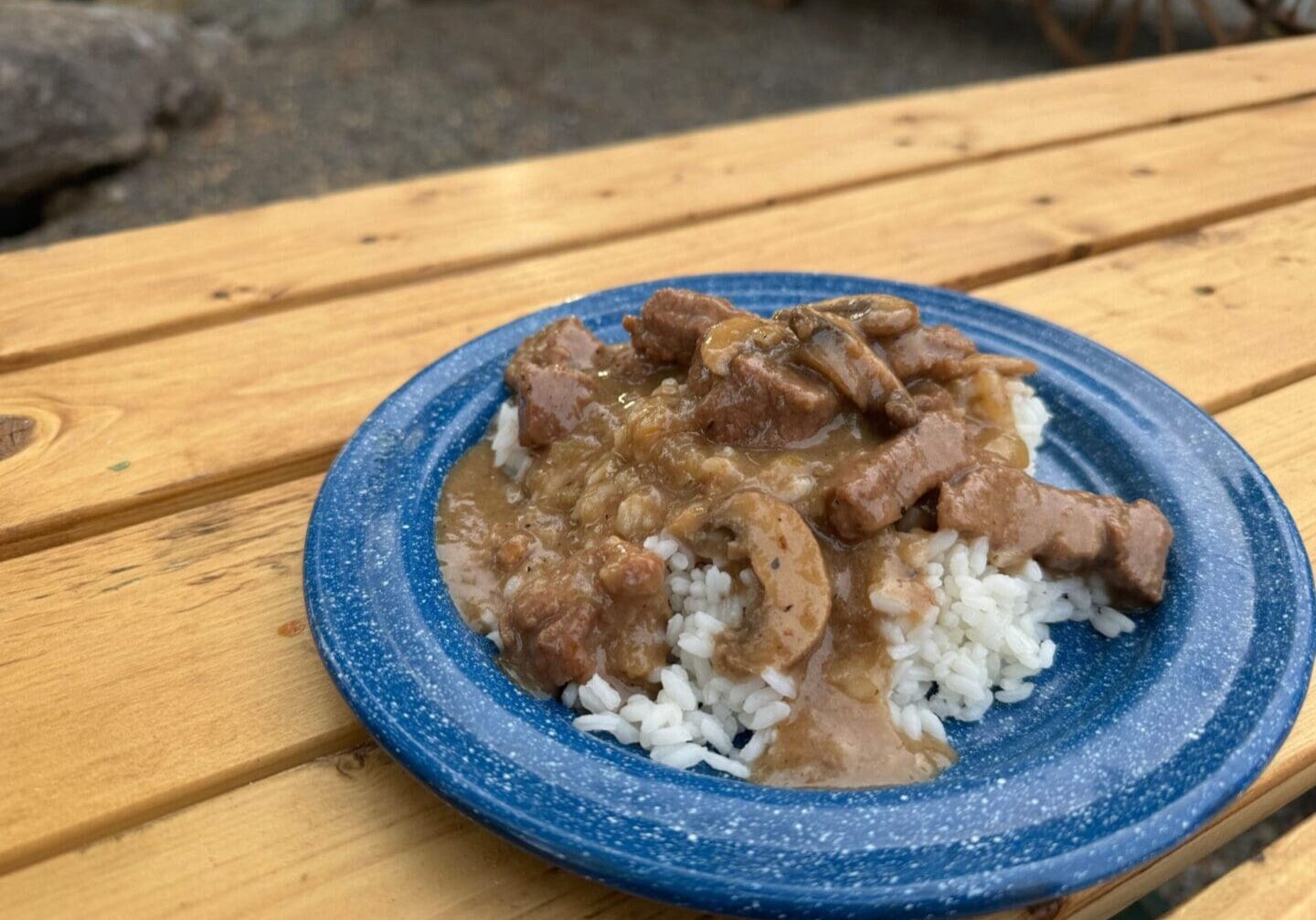 Cowboy Kent Rollins beef tips and rice on a blue enamel plate