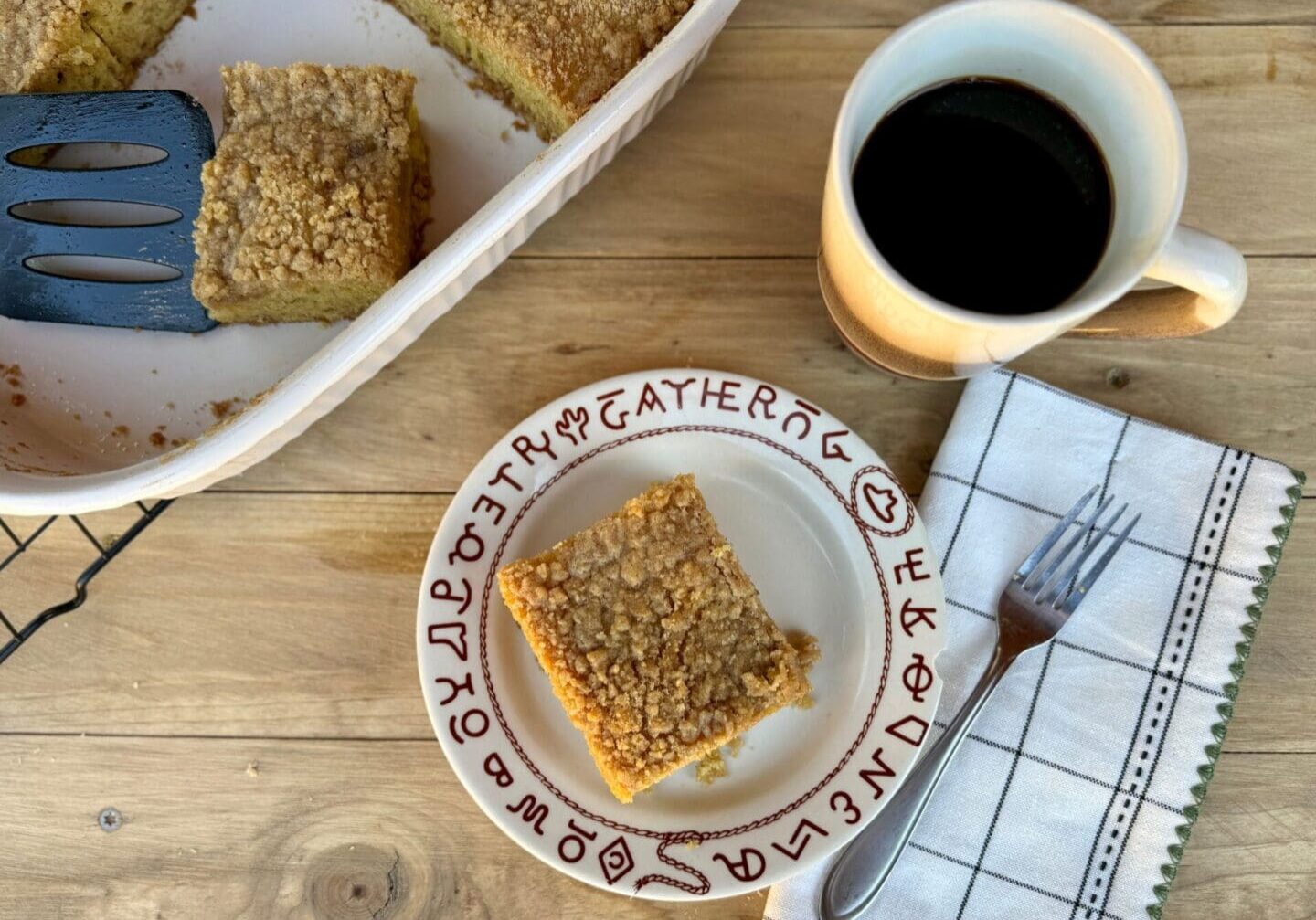 Cowboy Kent Rollins' Coffee and Coffee Cake, next to a linen napkin and a fork