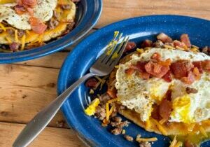Cowboy Kent Rollins' Mexican Breakfast skillet with homemade tostada, sausage, bacon, and over=easy egg.