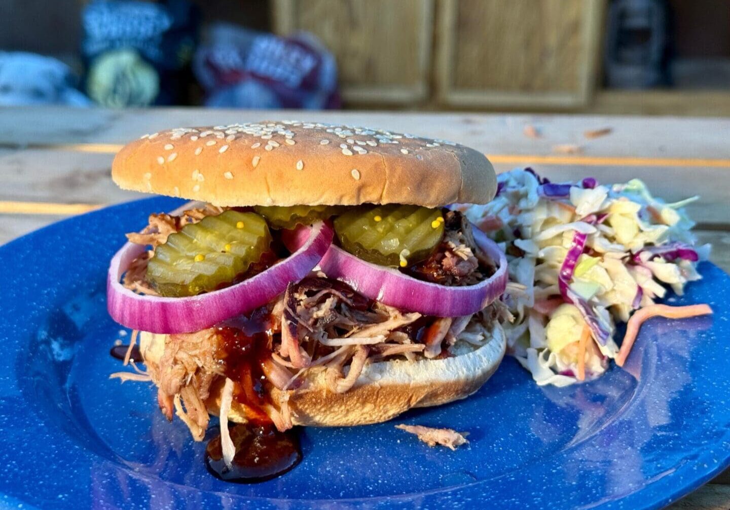 Kent Rollins Pulled Pork Sandwich on a blue plate with cole slaw